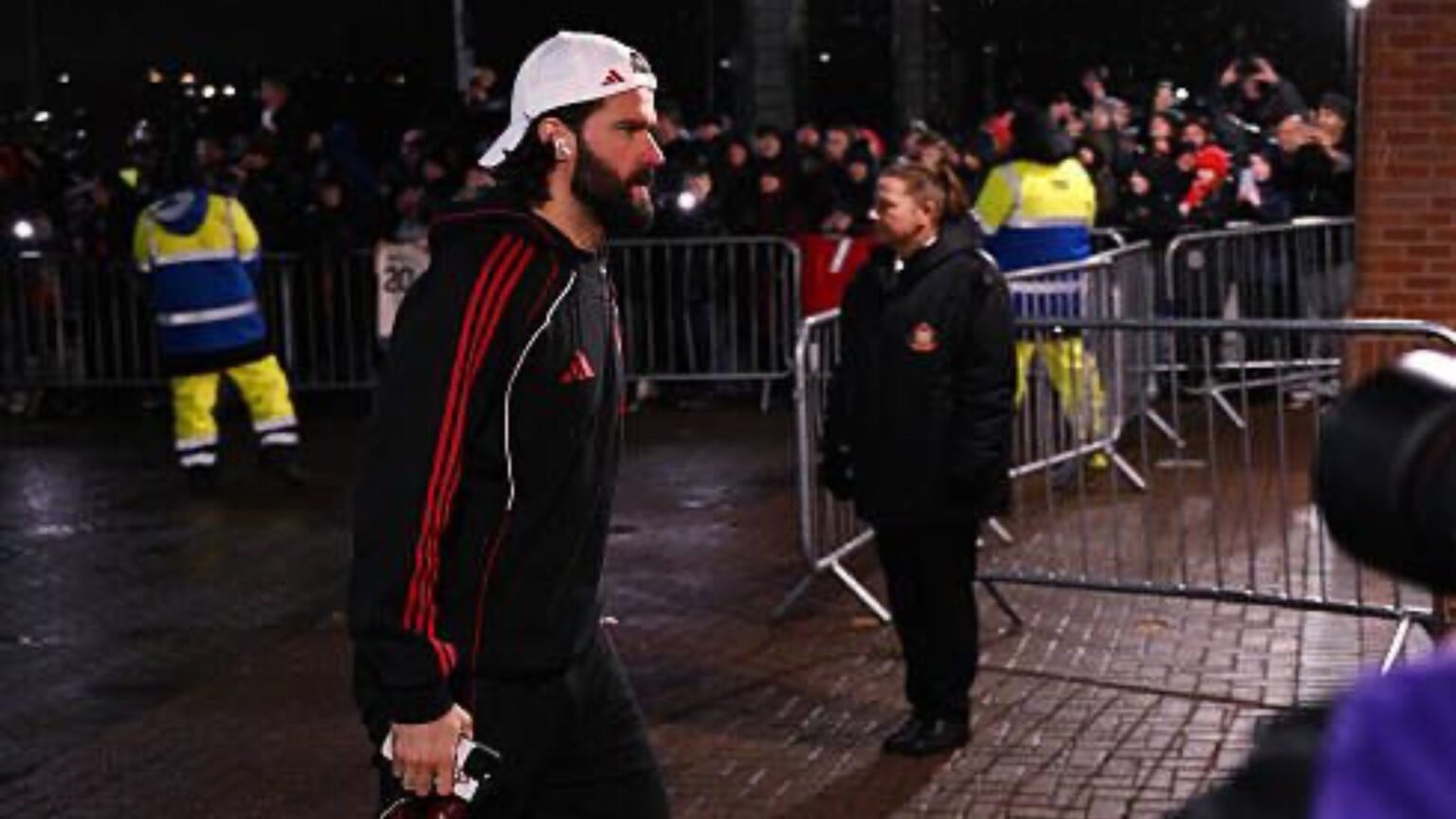 Alisson Becker contract: Alisson Becker arriving at a venue wearing gear.