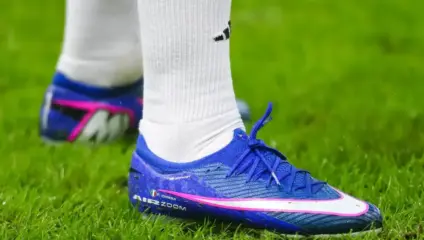 Chiesa January exit: Close-up of Federico Chiesa's Liverpool-branded personalized football boots on the pitch.
