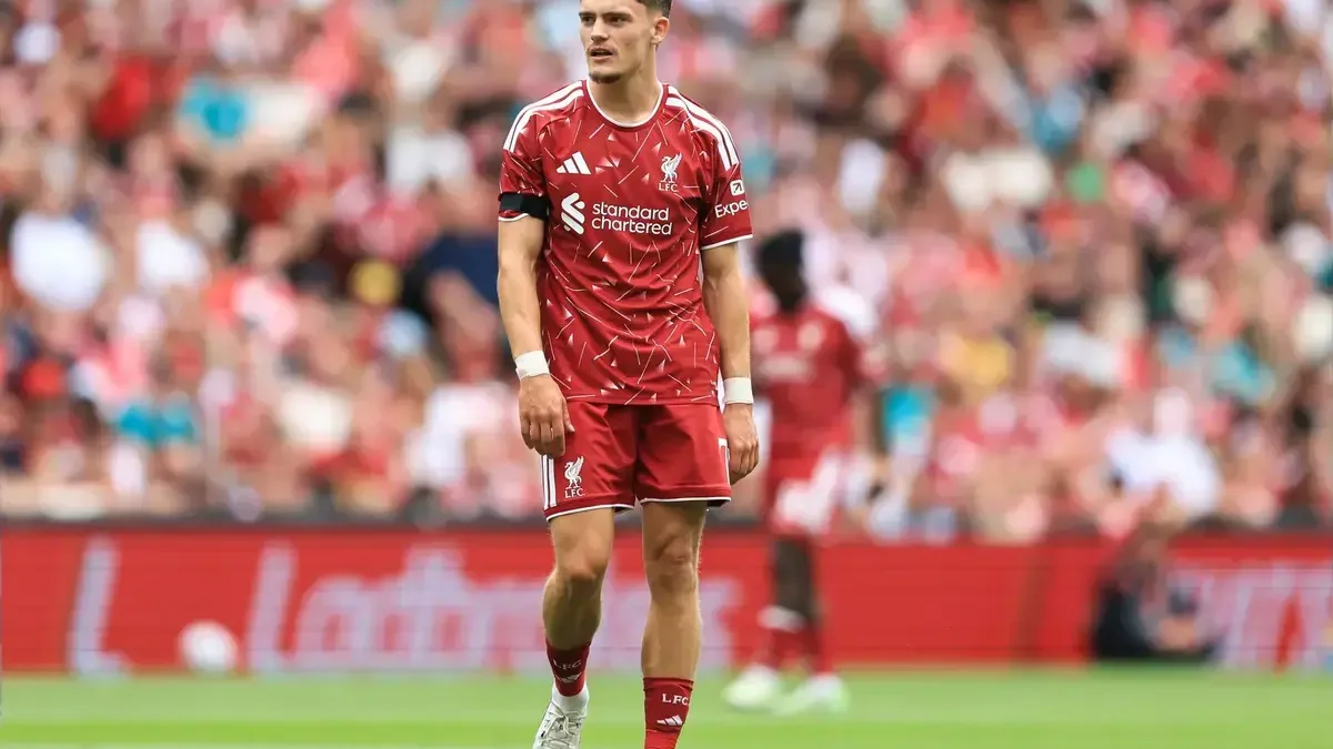 Florian Wirtz in a Liverpool kit during a match, standing on the pitch