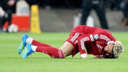 Hugo Ekitike injury return: Hugo Ekitike lying injured on the pitch during a Liverpool match.